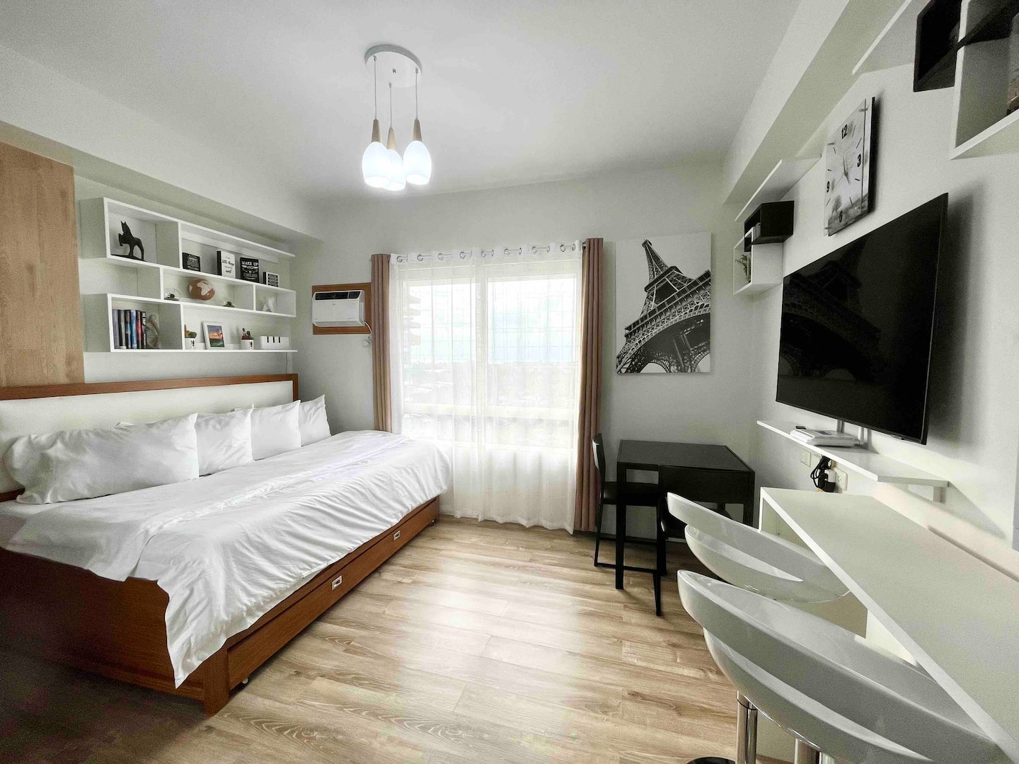 Bright studio with bed, workspace and smart TV