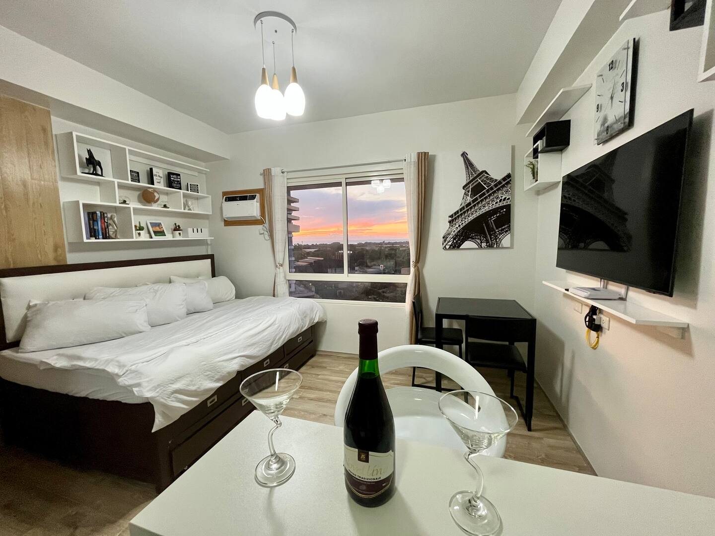 Comfy bed beside a window with sunset views