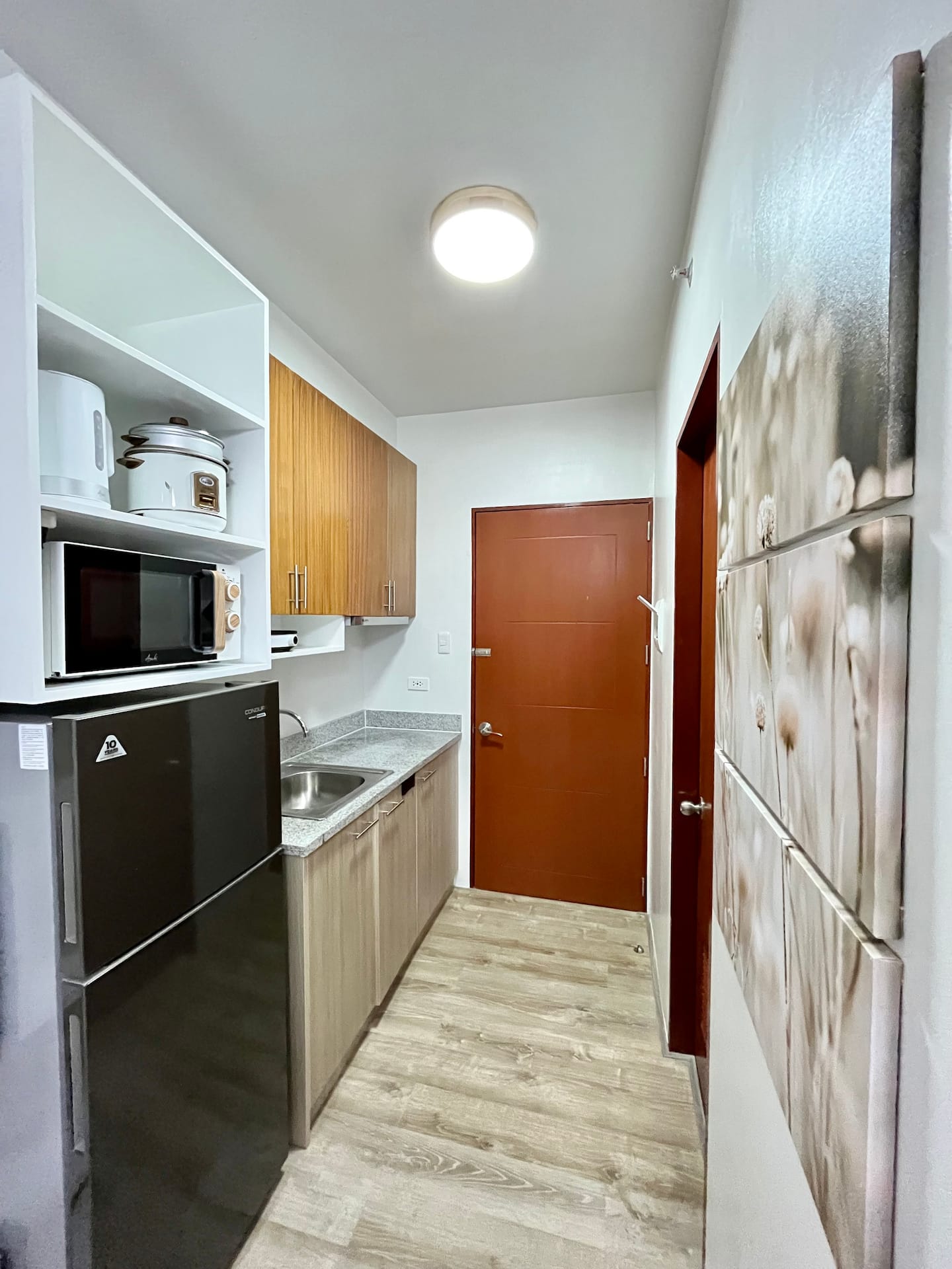 Kitchenette with fridge, stove and cookware